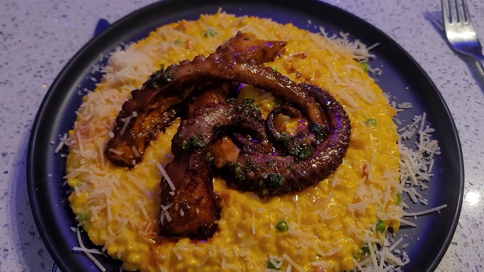 Plates of Peruvian seafood on a restaurant table